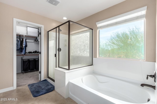 full bath with visible vents, recessed lighting, a shower stall, a spacious closet, and a garden tub