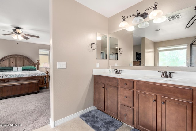 bathroom with baseboards, visible vents, ensuite bathroom, and a sink