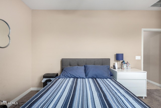 carpeted bedroom with baseboards and visible vents