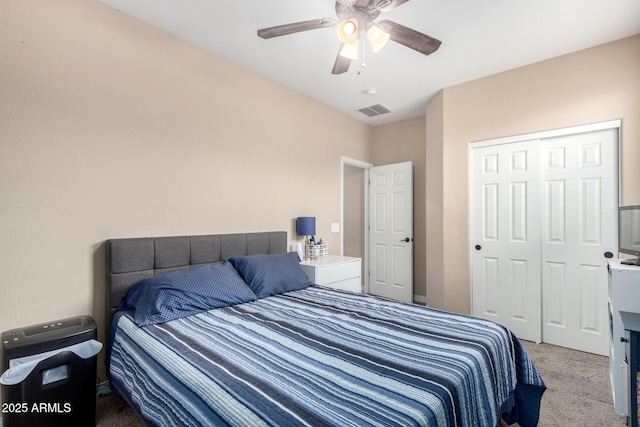 carpeted bedroom with visible vents, a closet, and ceiling fan