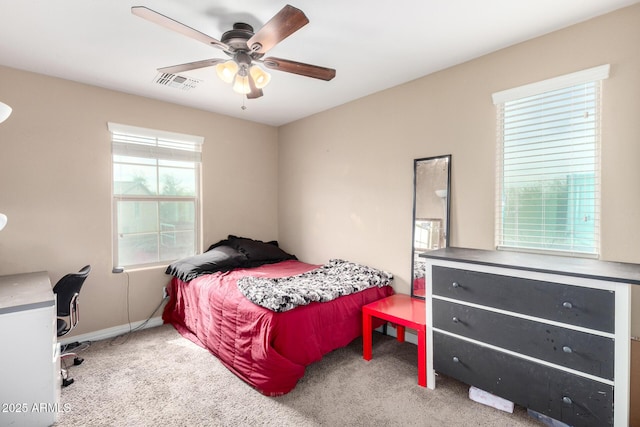 bedroom with visible vents, carpet floors, baseboards, and a ceiling fan