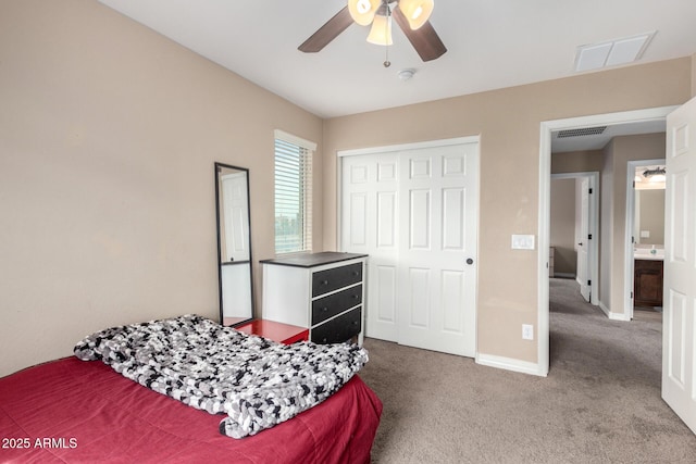 bedroom with a closet, visible vents, baseboards, and carpet floors