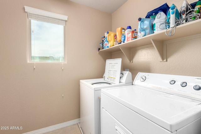 laundry area featuring laundry area, light tile patterned floors, baseboards, and washer and clothes dryer