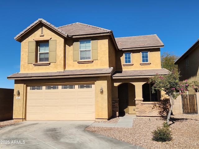 traditional home featuring stucco siding, driveway, a porch, an attached garage, and a tiled roof