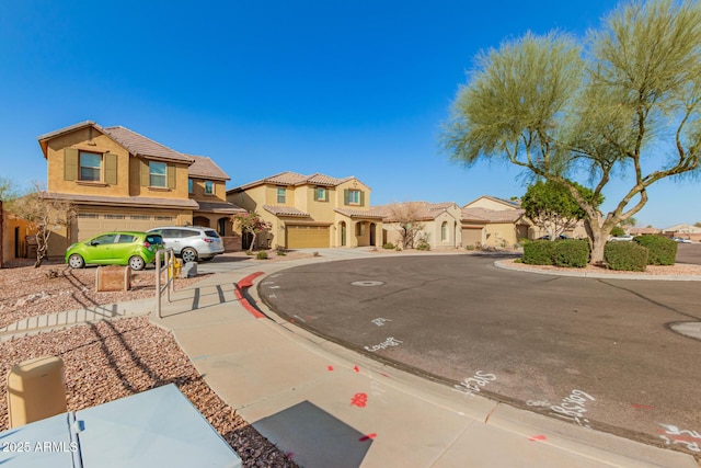 view of front of house with a tiled roof, a residential view, stucco siding, and driveway