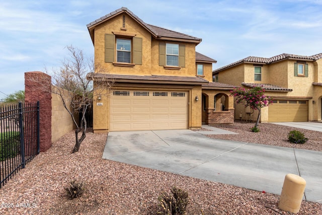 traditional-style house featuring stucco siding, driveway, a garage, and fence