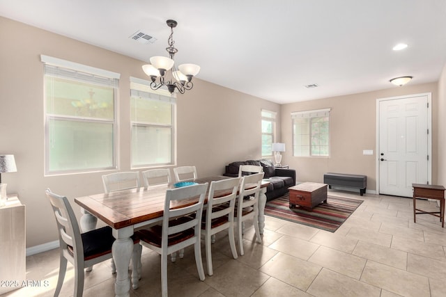 dining room with light tile patterned floors, visible vents, an inviting chandelier, and baseboards