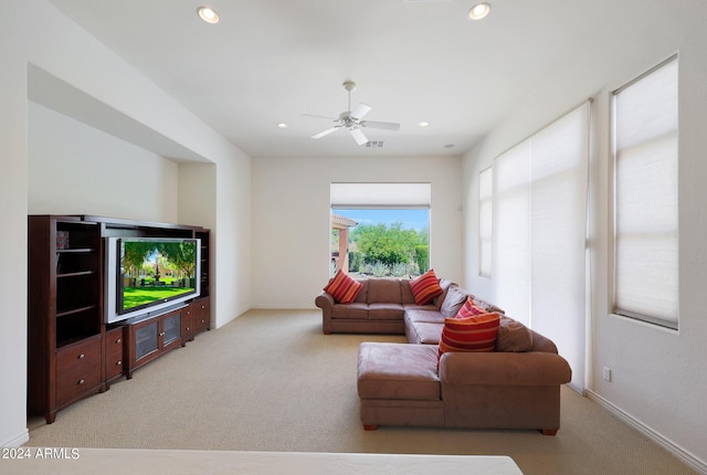 carpeted living room featuring ceiling fan