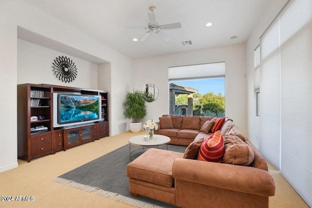 living room with light colored carpet and ceiling fan