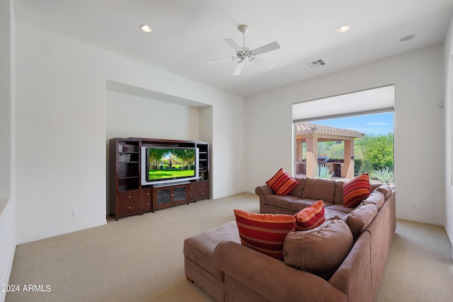 carpeted living room featuring ceiling fan