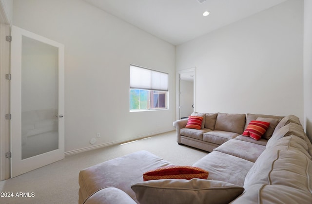 living room featuring light carpet and vaulted ceiling