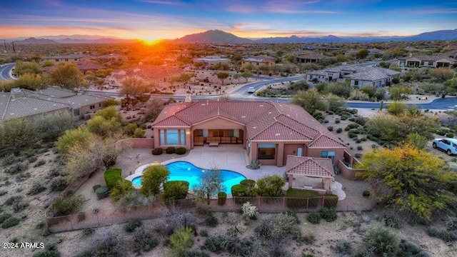 aerial view at dusk featuring a mountain view