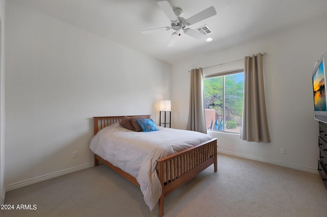 bedroom with light carpet and ceiling fan