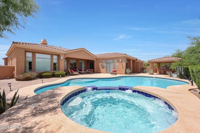 view of pool with an in ground hot tub, a gazebo, a patio, and an outdoor hangout area