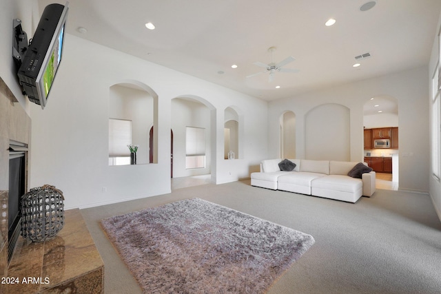 living room with carpet and ceiling fan