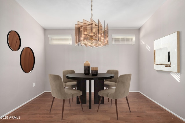 dining room featuring hardwood / wood-style flooring and a chandelier