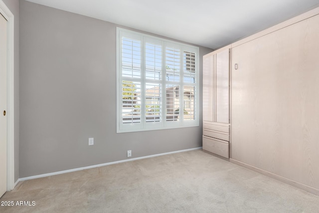 unfurnished bedroom with light carpet and a closet