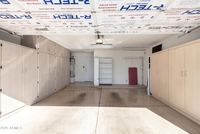 garage with a garage door opener and water heater