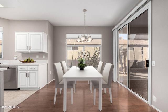 dining space with an inviting chandelier and light hardwood / wood-style flooring