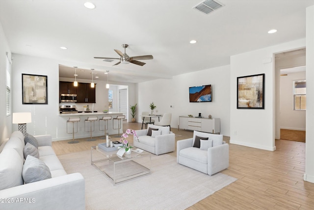 2187 W Burnside Trl, Phoenix, AZ 85085 - living room featuring a ceiling fan, light wood-style flooring, baseboards, and recessed lighting