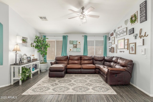 living room with ceiling fan, wood finished floors, visible vents, and baseboards