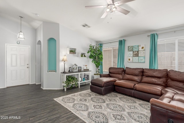 living room with lofted ceiling, ceiling fan, dark wood-style flooring, visible vents, and baseboards