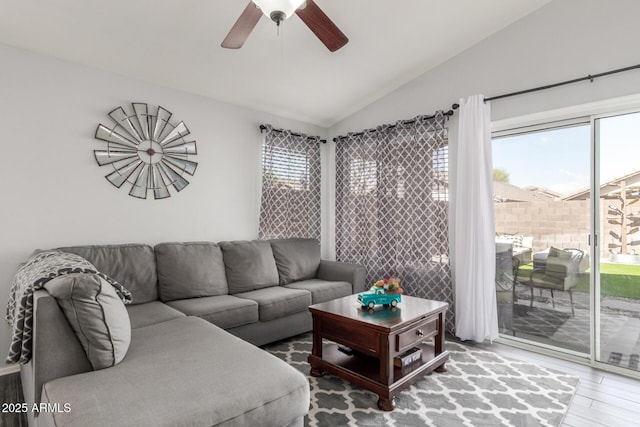 living room featuring a ceiling fan, lofted ceiling, and wood finished floors