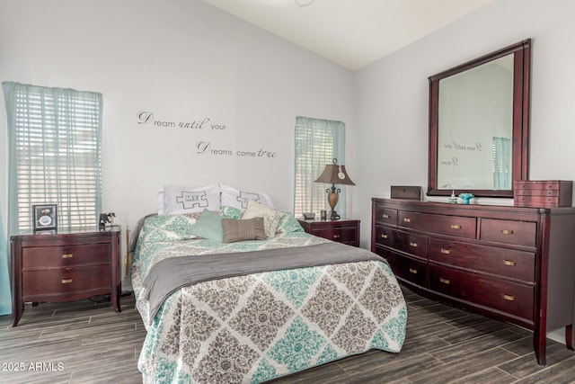 bedroom featuring lofted ceiling and wood tiled floor