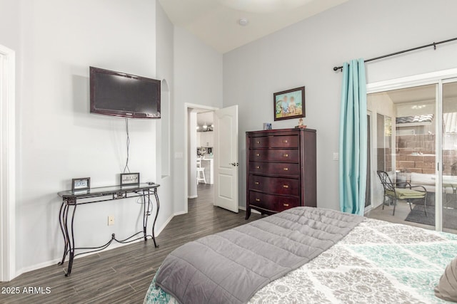 bedroom with dark wood-type flooring, access to outside, and baseboards