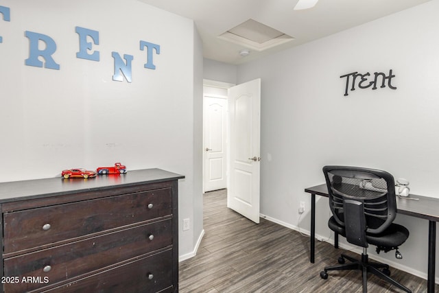 office space with dark wood-type flooring, attic access, and baseboards