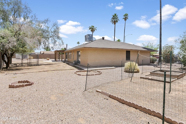 1334 S Glenview Cir, Mesa, AZ 85204 - back of house featuring central AC unit, a patio area, a garden, and stucco siding