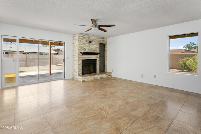 1334 S Glenview Cir, Mesa, AZ 85204 - unfurnished living room with healthy amount of natural light, ceiling fan, a fireplace, and a textured ceiling