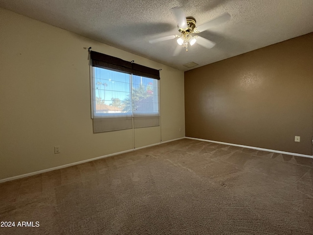 carpeted empty room featuring a textured ceiling and ceiling fan