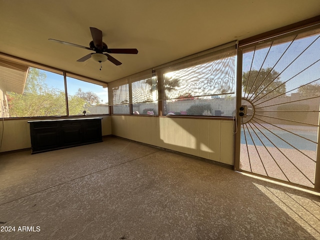 unfurnished sunroom with ceiling fan