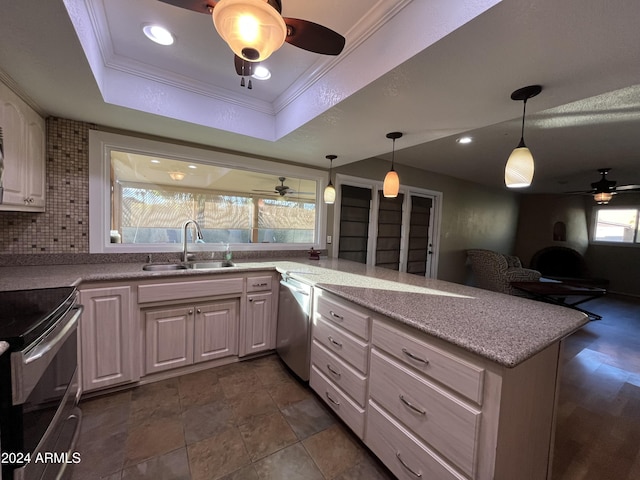 kitchen featuring decorative backsplash, appliances with stainless steel finishes, a healthy amount of sunlight, and sink