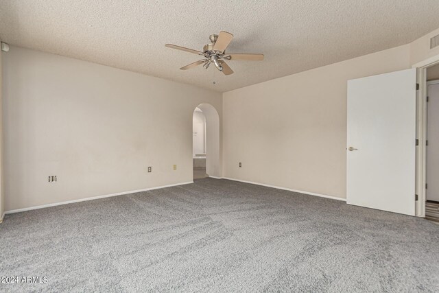 empty room with carpet floors, a textured ceiling, and ceiling fan