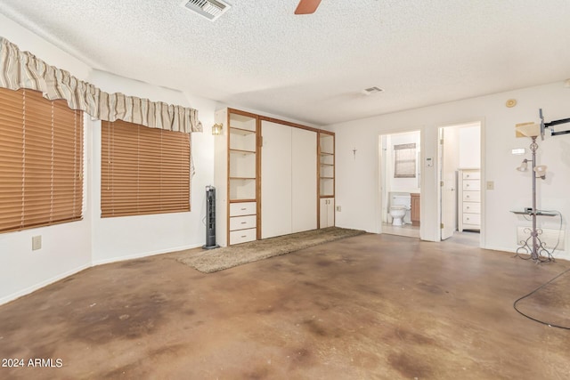 garage featuring visible vents, baseboards, and ceiling fan