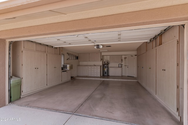 garage with a garage door opener and water heater