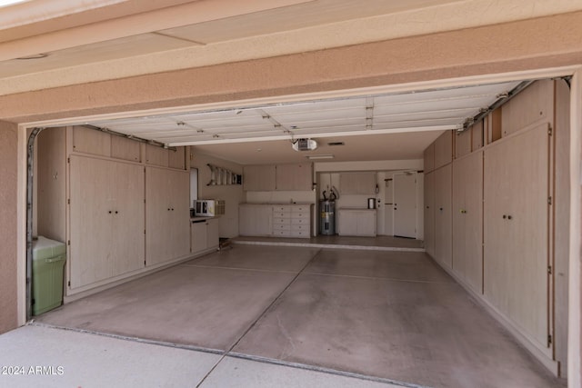 garage with electric water heater and a garage door opener