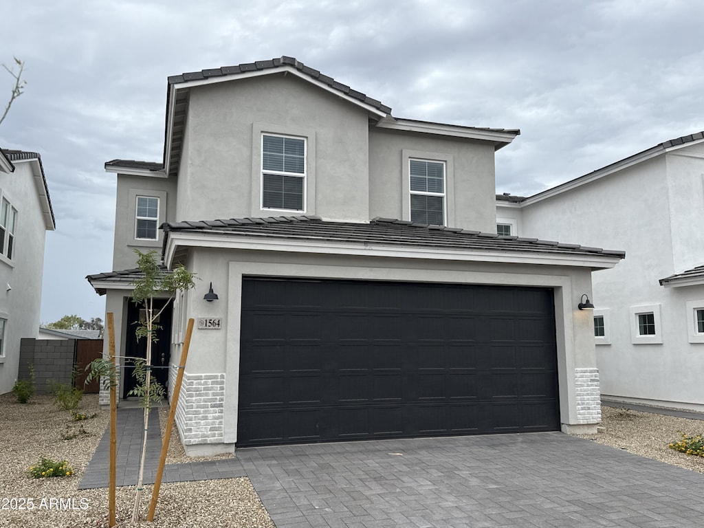 1530 N Pueblo Dr, Apache Junction, AZ 85120 - traditional-style house featuring driveway, an attached garage, stucco siding, and a tiled roof