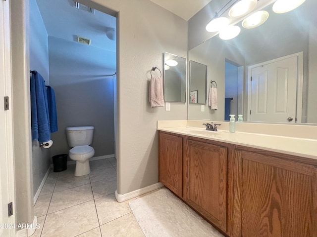 bathroom with tile patterned floors, vanity, and toilet