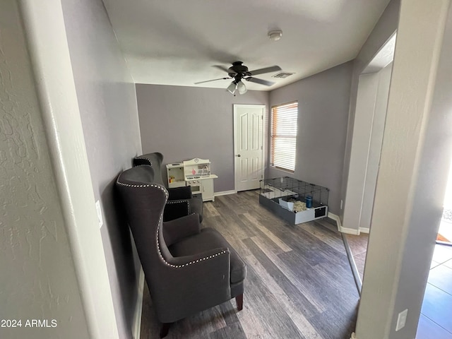 sitting room with dark hardwood / wood-style flooring and ceiling fan