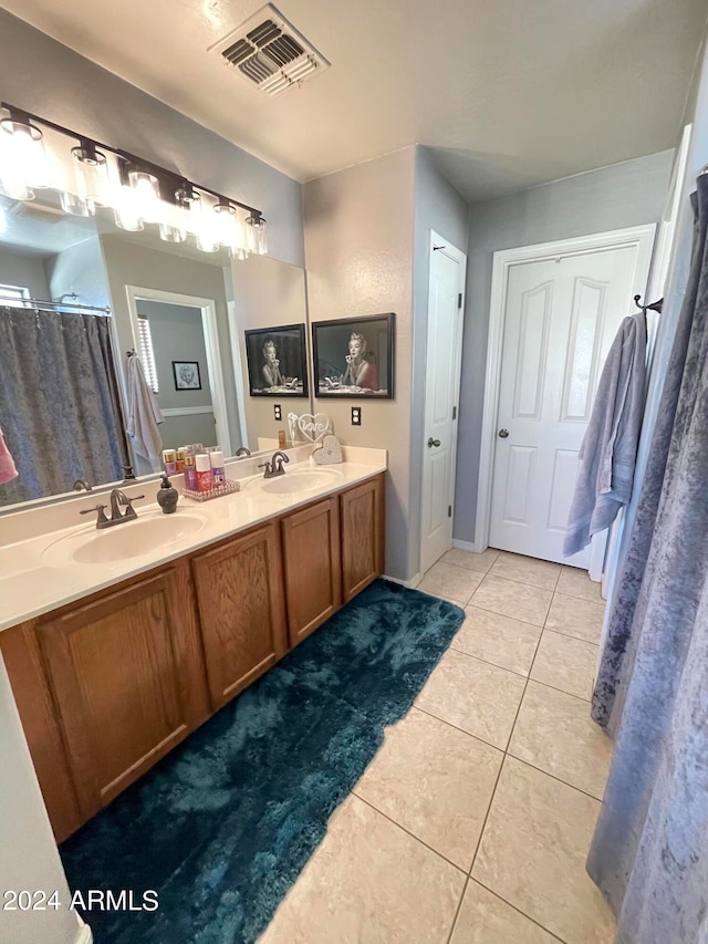 bathroom featuring tile patterned flooring and vanity