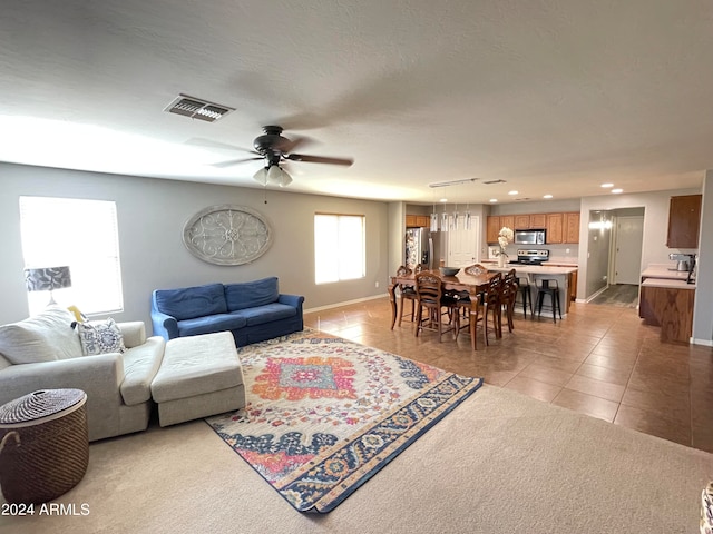 living room featuring ceiling fan and light tile patterned flooring