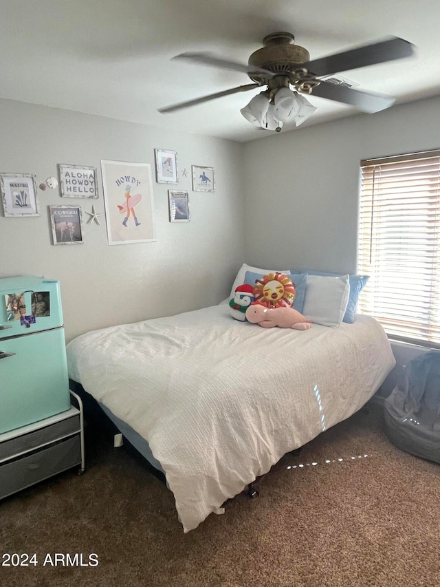 bedroom with ceiling fan and dark carpet