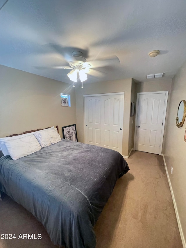 bedroom with ceiling fan and light colored carpet