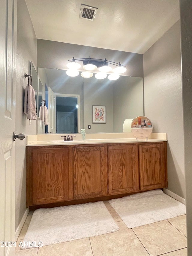 bathroom with tile patterned floors and vanity