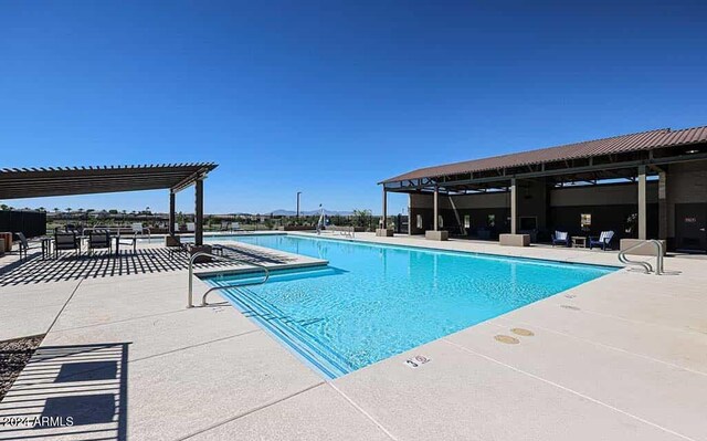 view of swimming pool featuring a pergola and a patio