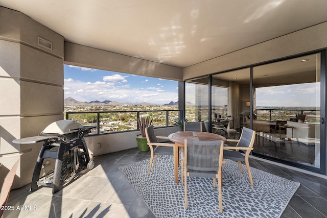 balcony featuring a mountain view and grilling area