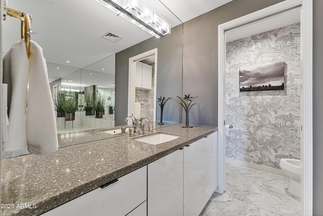 bathroom featuring vanity, marble finish floor, wallpapered walls, visible vents, and a bidet